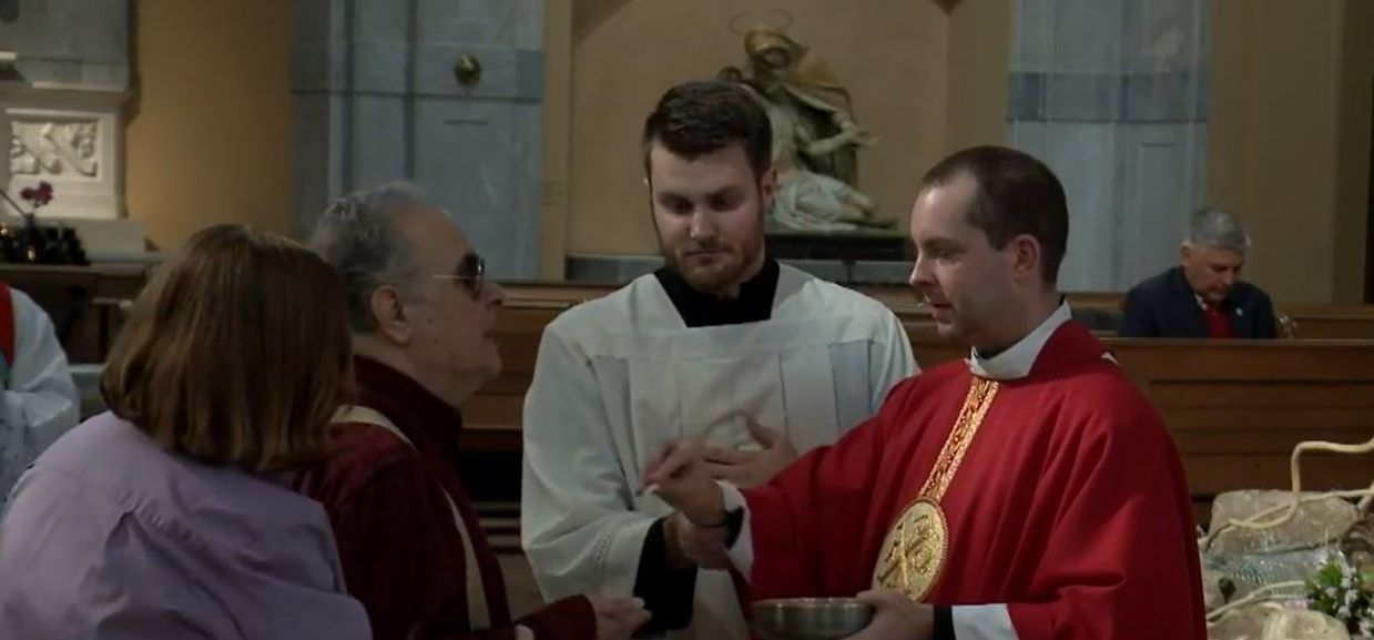 Fr. Jamie distributes Communion